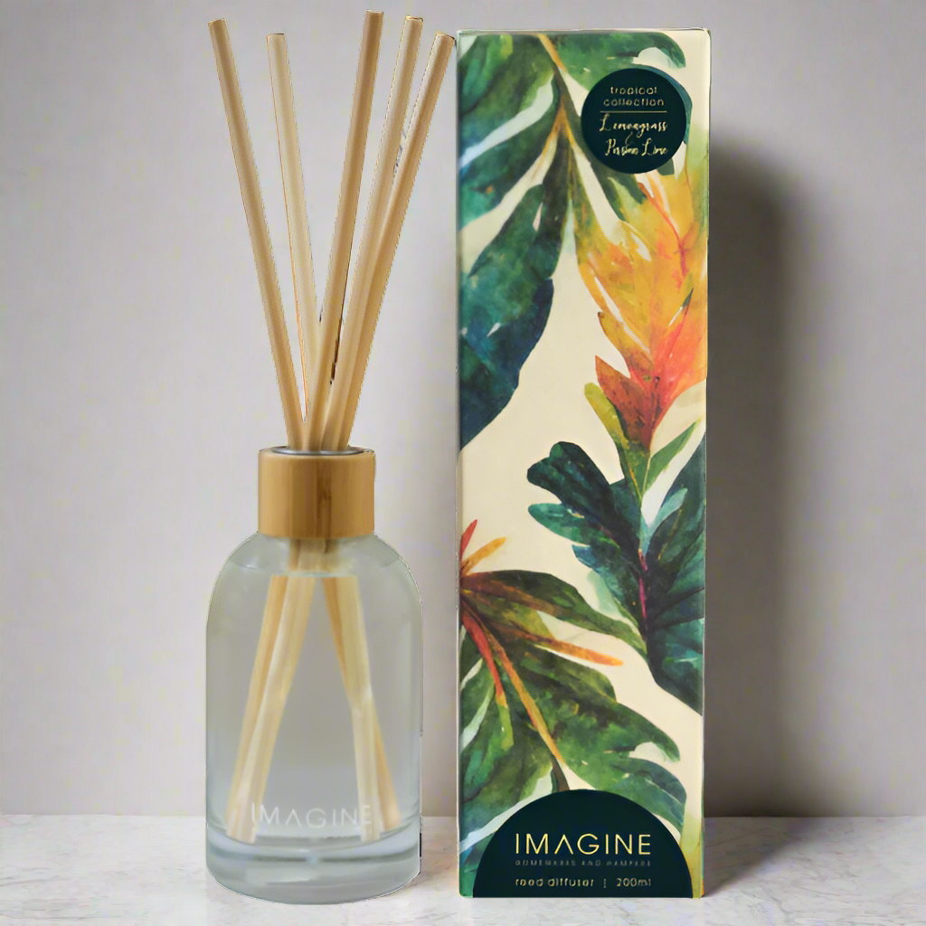 Reed diffuser with wooden sticks and a colorful leaf-patterned box on a white background