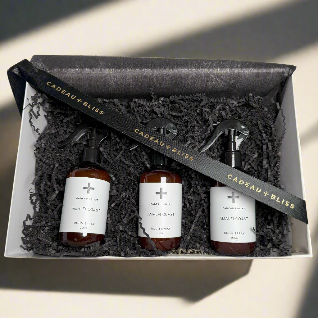 Three bottles of 'Amalfi Coast' body spray in a 'Cadeau + Bliss' gift box.